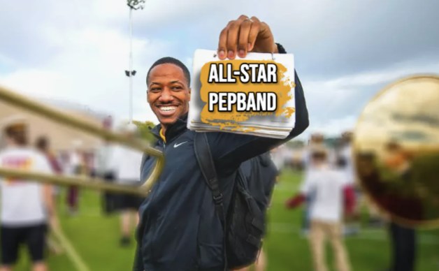 Daniel James Felton holding an All-Star Pep Band music folder